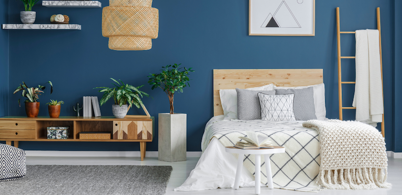 Charming bedroom adorned with blue walls and elegant furniture, offering a serene and peaceful vibe.