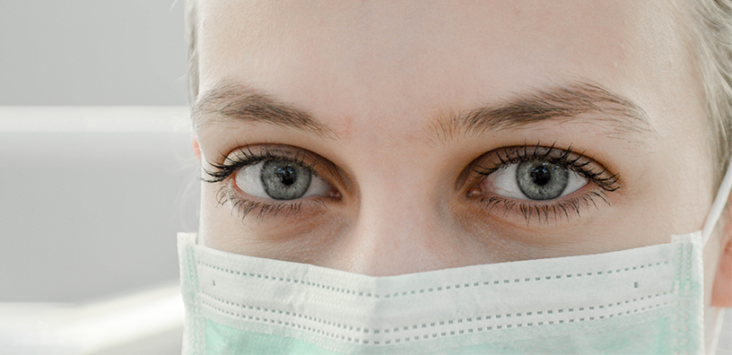 A woman using a face mask.