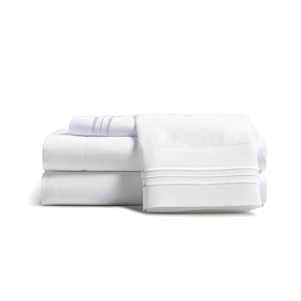 Cosy House Collectionâs Everyday Bed sheets and pillowcases stacked together.