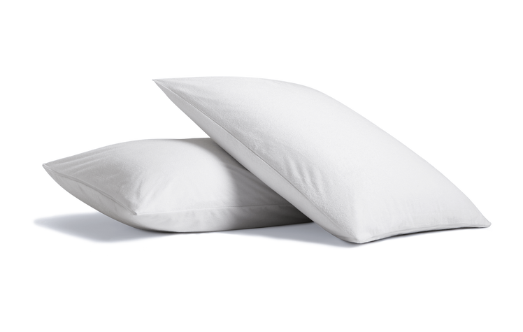 A pair of pillows covered with Cosy House Collection Luxury Waterproof Zippered Pillow Protectors.
