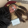 Person lying on a couch with a pillowcase packaging