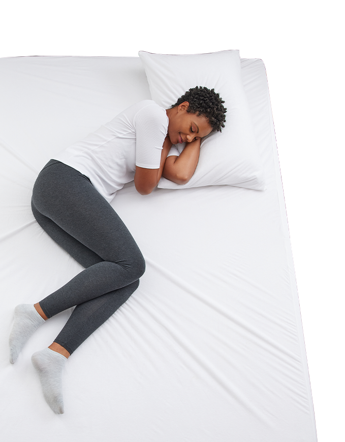 A woman enjoying a restful sleep with Cosy House Collection bedding.