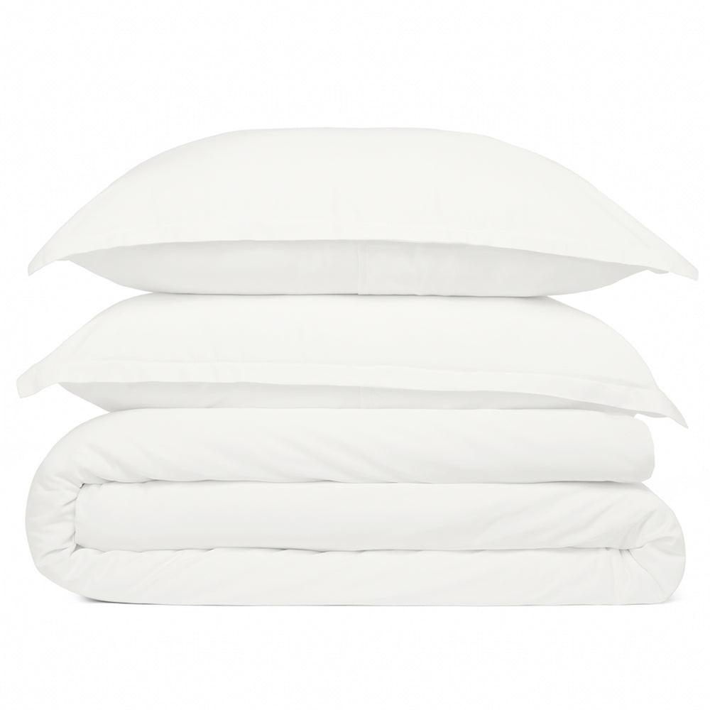 White bedding set with duvet and pillows on a white background