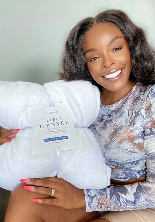 A happy customer showing her Everyday Fleece Blanket.