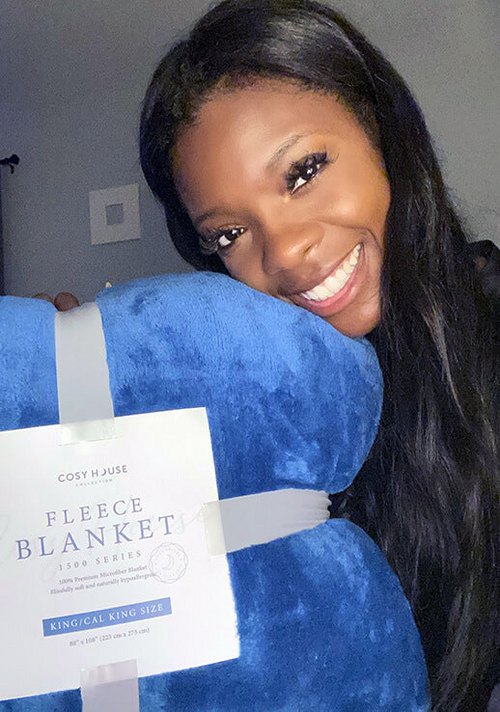 A very satisfied customer showing her Everyday Fleece Blanket.