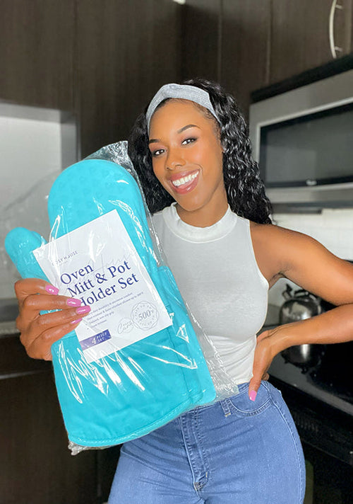 A smiling customer showing her packaged Cosy House Collection’s Oven Mitt & Pot Holder Set.