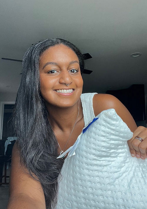 Another smiling customer showing her Luxury Body Pillow.