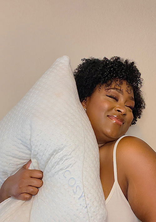 A happy customer hugging a Luxury Body Pillow.