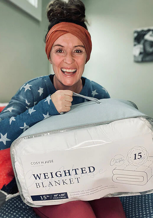 A very happy customer holding her Weighted blanket.