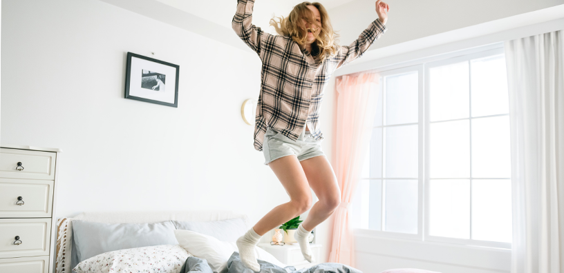woman-jumping-on-bed