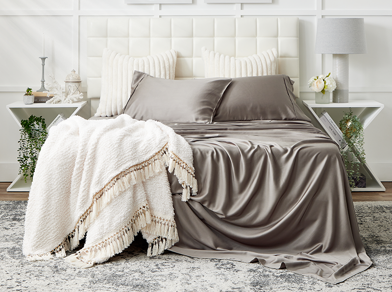 A cozy bed with Cosy House Collection bedding, offering a tranquil and comfortable sleeping space.