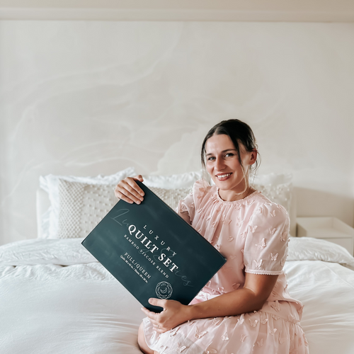 Another female customer is comfortably sitting on her bed showing her Luxury Quilt set.