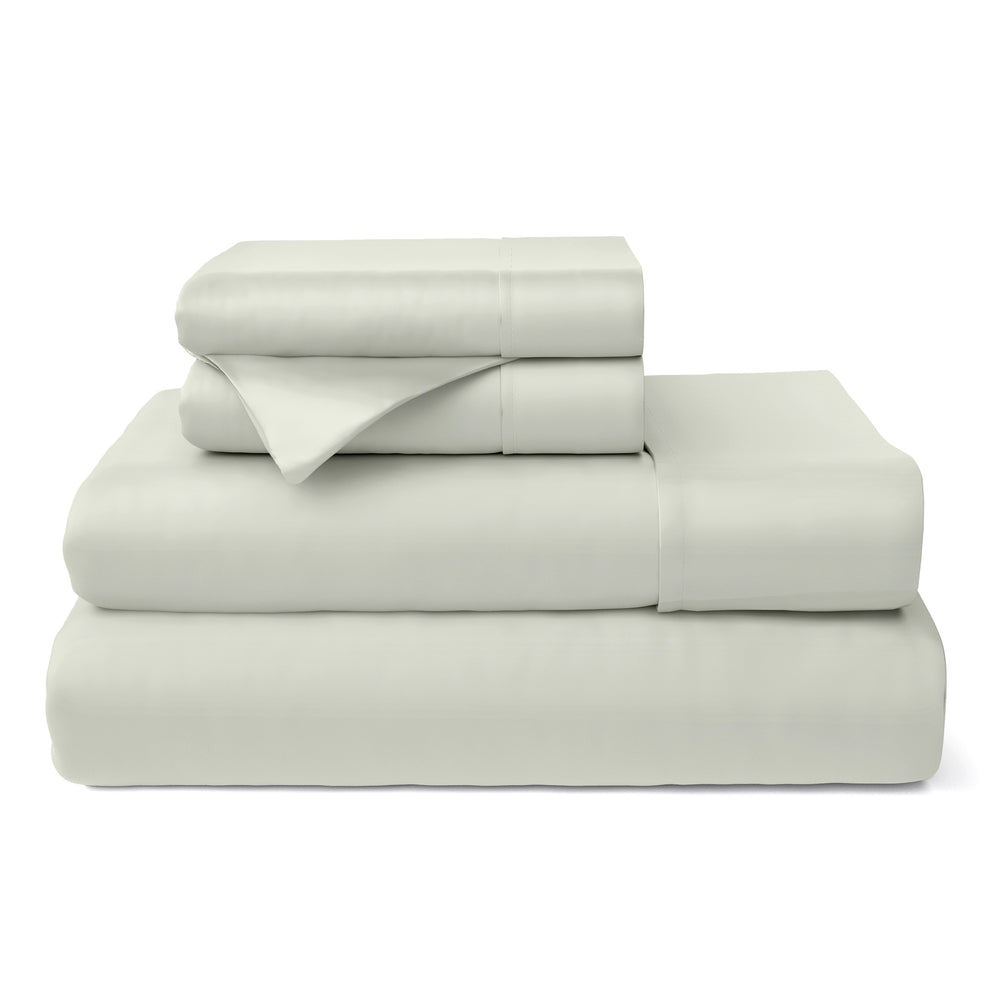 Stack of silver bed sheets on a white background