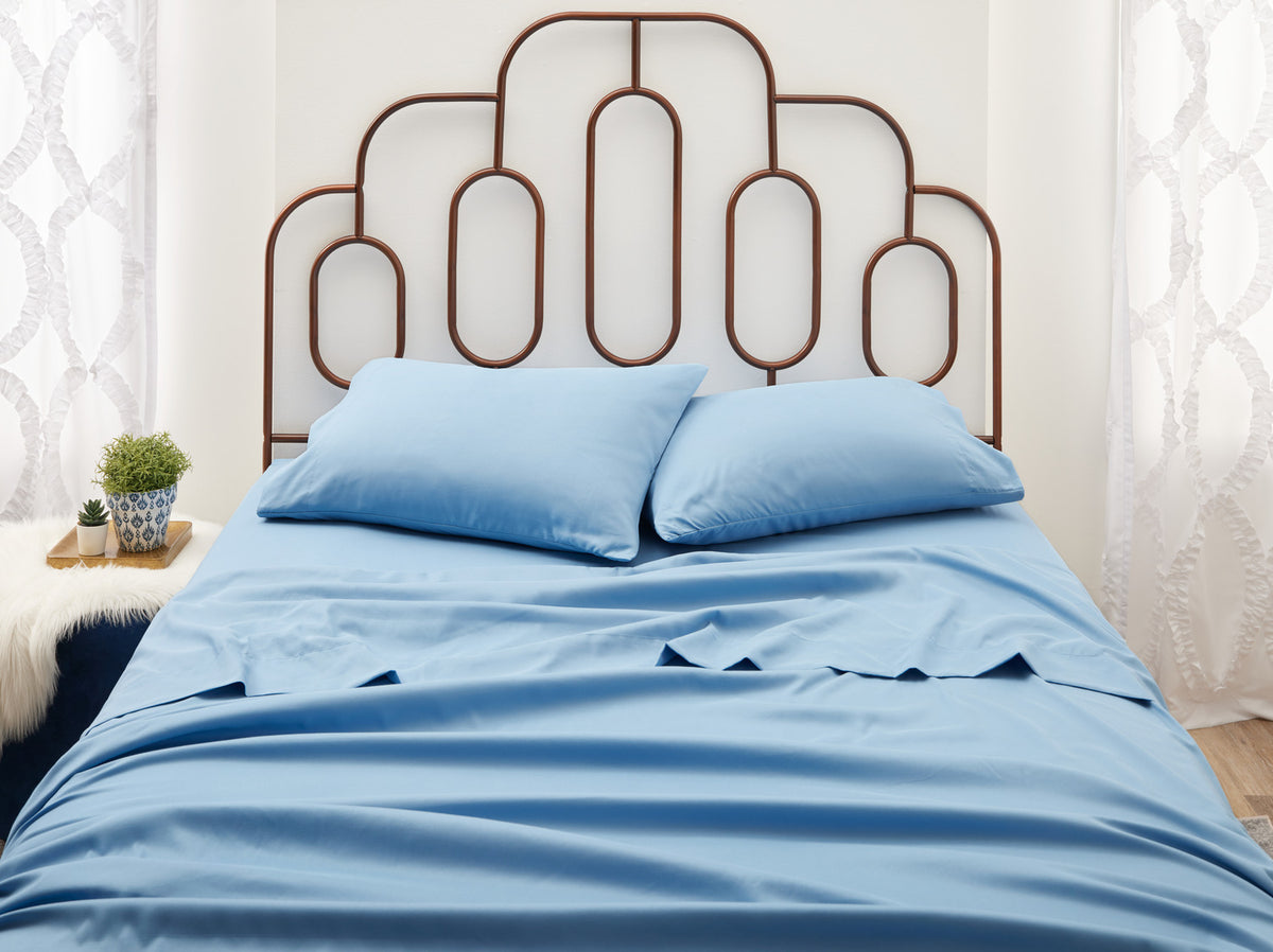 Blue sheets on a bed 3rd angle