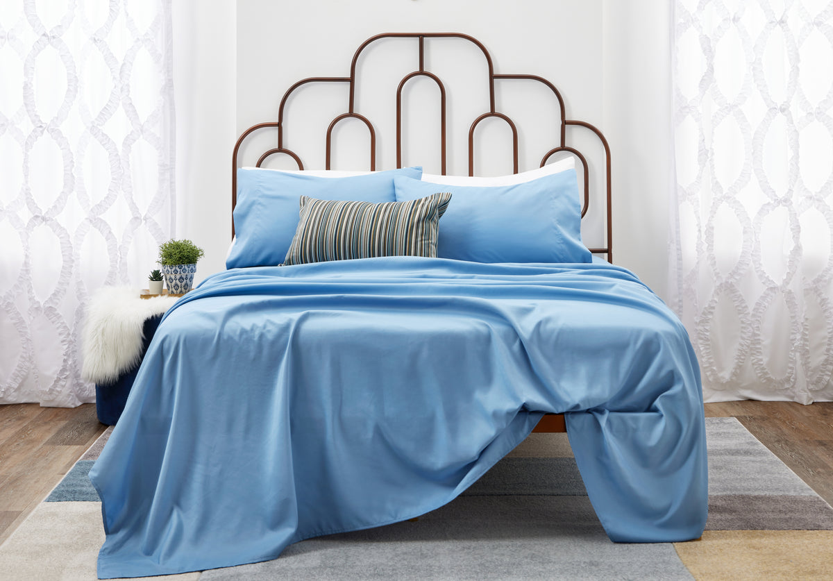 Blue sheets on a bed